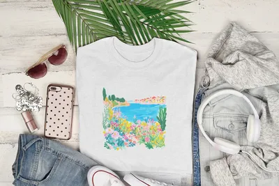 White crewneck t-shirt with a colorful floral and seaside graphic.