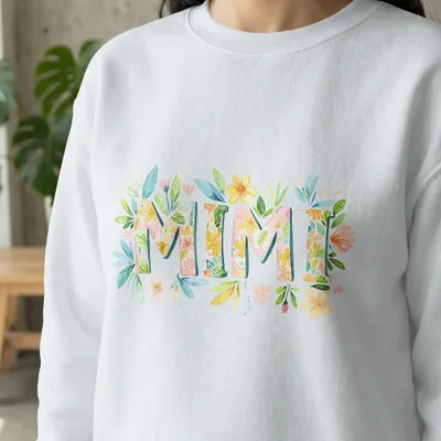 White sweatshirt with "MIMI" in floral lettering.