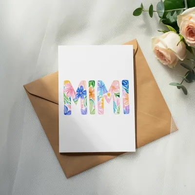 Card with "MIMI" written in floral watercolor letters, on an envelope.