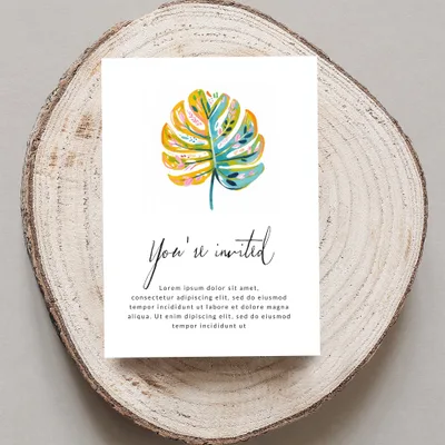 Invitation with painted monstera leaf and placeholder text.