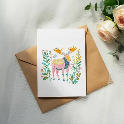 Greeting card with a colorful illustration of a moose surrounded by flowers.