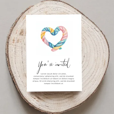 Invitation card with a colorful heart lollipop and "You're invited" text.