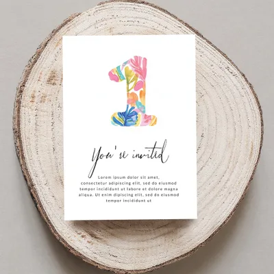"You're invited" card with a colorful "1" on a wood slice.