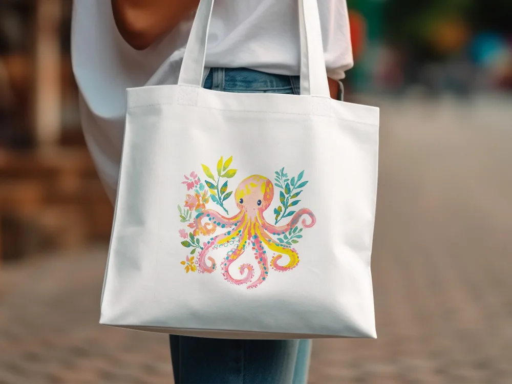 White tote bag with a pink and yellow watercolor octopus and floral design.