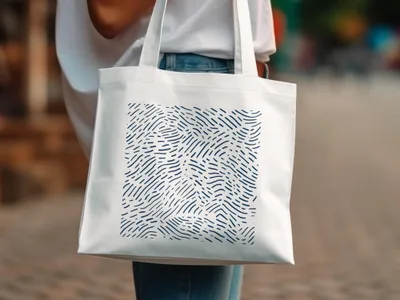White tote bag with a dark blue abstract wavy line pattern.