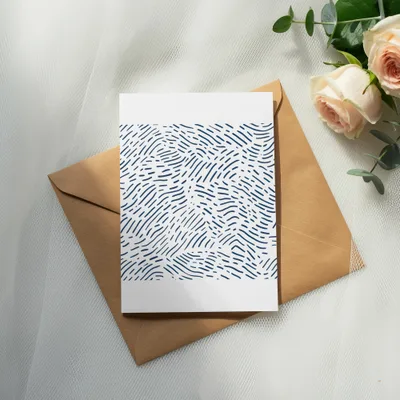 Card with blue abstract pattern on brown envelope and roses.