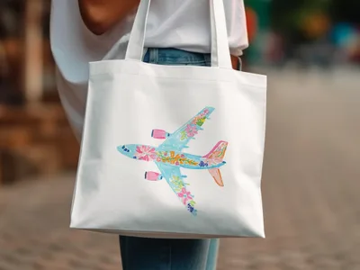 White tote bag with a watercolor illustration of a floral airplane.
