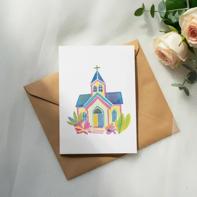 Watercolor painting of a colorful church with flowers, on an envelope.