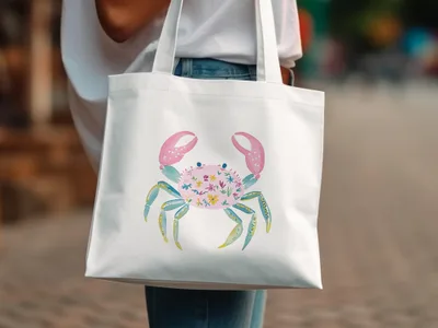 White tote bag featuring a blue crab illustration with floral pattern.