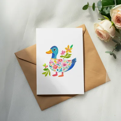 Card with a painted duck wearing a colorful floral sweater.