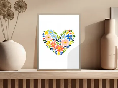 Floral heart art print with colorful flowers on a wooden shelf.