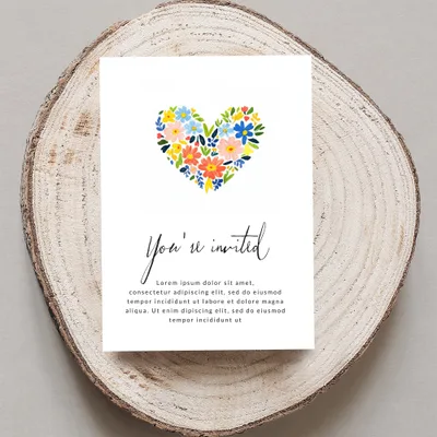Invitation card with "You're invited" and floral heart design.