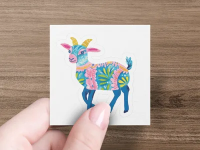 Stylized goat illustration with colorful floral patterns on a sticker.