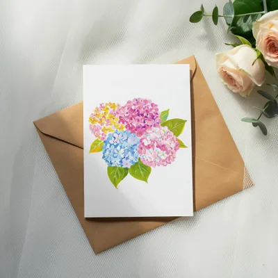 Card with colorful hydrangeas on brown envelope and roses.