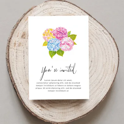 Invitation with colorful flowers and "You're invited" text.