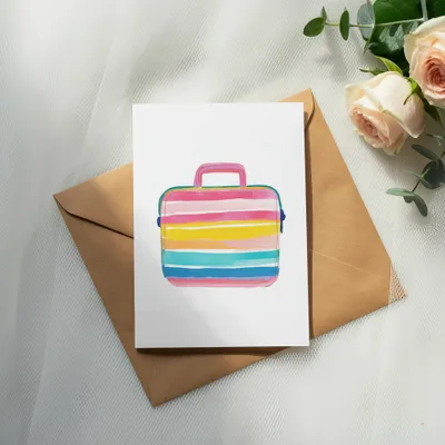 Watercolor illustration of a colorful striped briefcase on a kraft envelope.
