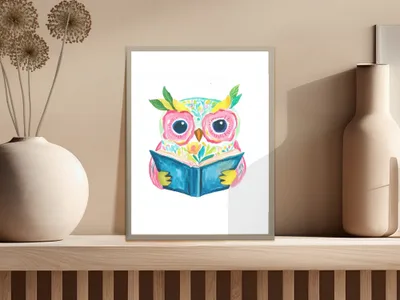 Watercolor owl with bright eyes reading an open book, framed.