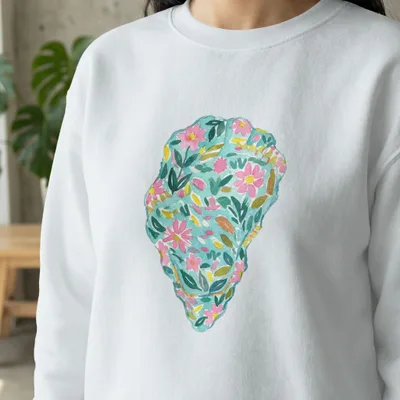White sweatshirt with a colorful watercolor floral oyster shell design.