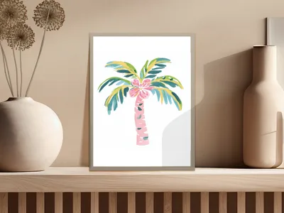 Palm tree illustration with pink flowers in a framed print on a shelf.