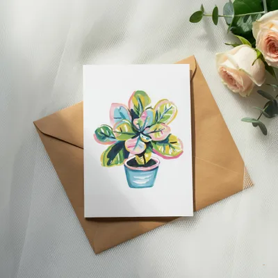 Watercolor illustration of a potted fiddle-leaf fig plant on a card.