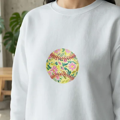 White sweatshirt featuring a yellow softball with a floral design.