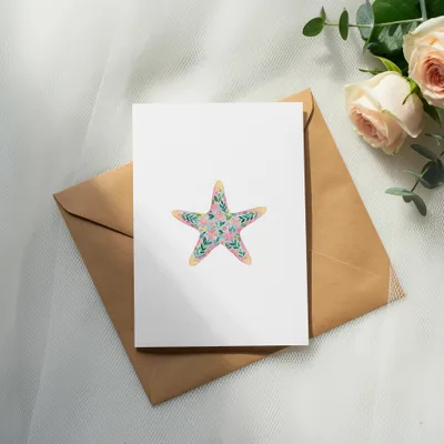 White card with floral starfish illustration on brown envelope.