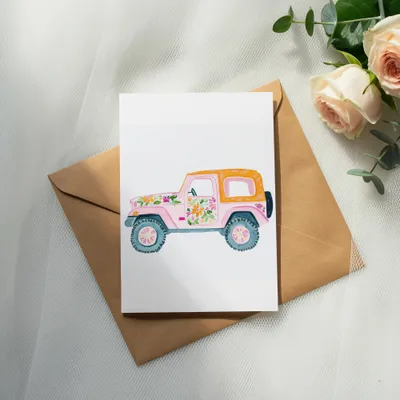 Watercolor illustration of a pink jeep with floral details on a brown envelope.