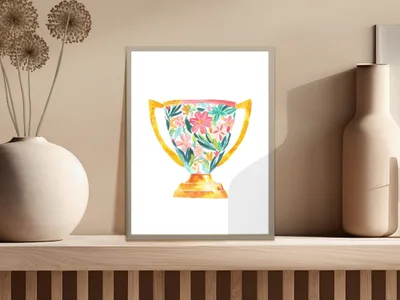 Watercolor trophy with colorful floral design, displayed on a shelf.