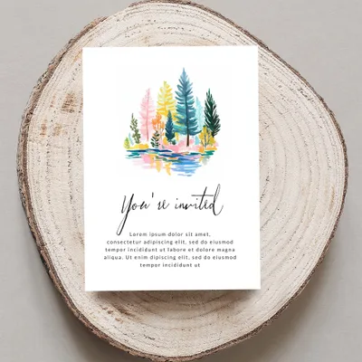 Invitation with colorful watercolor trees and reflective water, reads "You're invited"