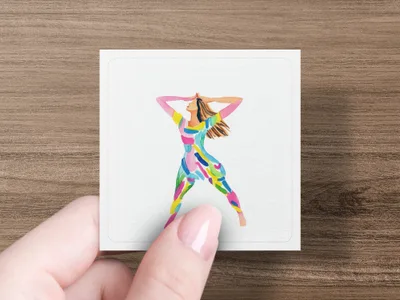 Woman in colorful, abstract patterned jumpsuit with arms raised.