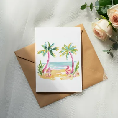 Watercolor beach scene with palm trees on a card atop a brown envelope.