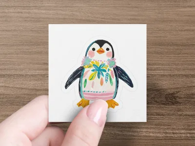 Penguin sticker with floral lei and colorful painted body.