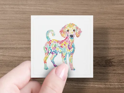 Watercolor poodle illustration with colorful spots on a white card held by a hand.