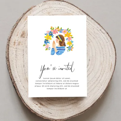 Invitation with "You're invited" and placeholder text on wood slice.