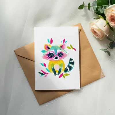 Card featuring a colorful, cartoon raccoon wearing sunglasses and sitting on a brown envelope.