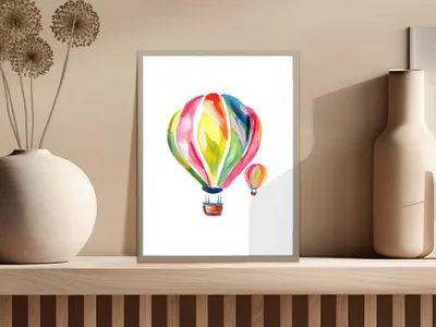 Colorful hot air balloons depicted in a watercolor painting in a framed print.