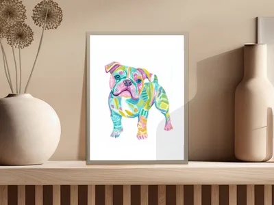 Colorful abstract bulldog painting in a frame on a shelf.