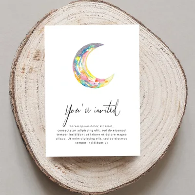 Watercolor crescent moon and "You're invited" text on card.