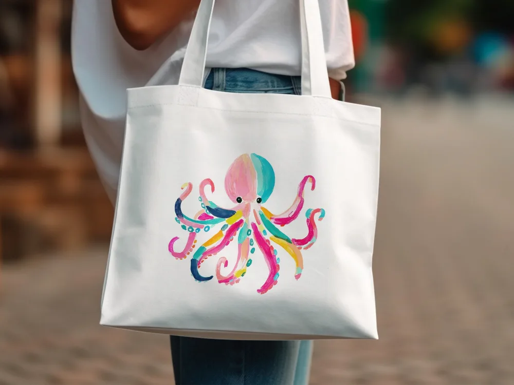 White canvas tote bag with a colorful octopus illustration.