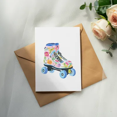 Floral watercolor roller skate on a card on a brown envelope.