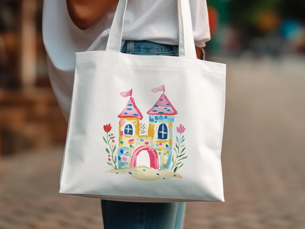 White tote bag with watercolor illustration of a colorful castle with pink flags.