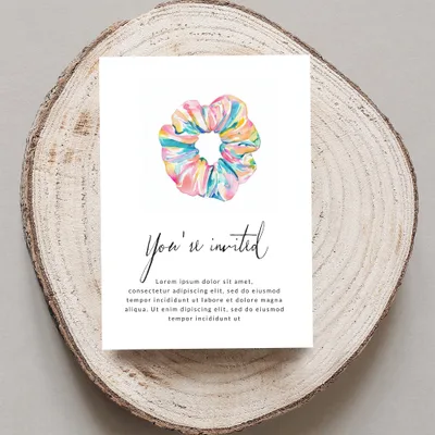 Invitation card with colorful scrunchie and "You're invited" text.