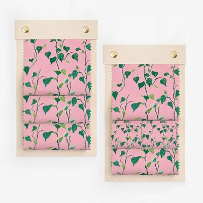 Two fabric swatches with a pink background and green vine pattern.