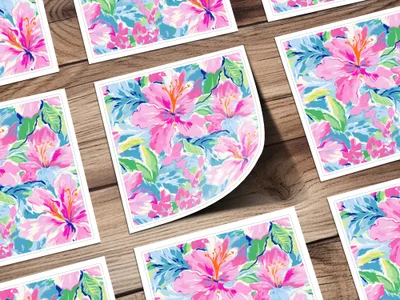 Floral pattern cards with pink and blue hibiscus flowers on a wooden surface.