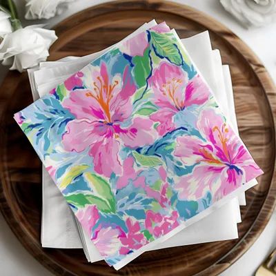 Pink and blue floral pattern on a folded stack of napkins.