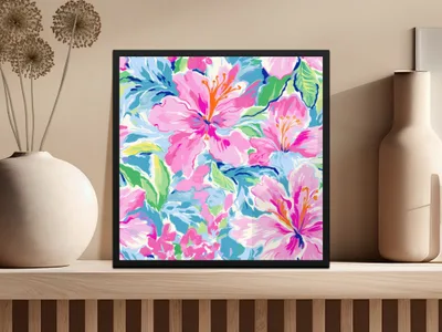 Framed artwork featuring vibrant pink hibiscus flowers with green leaves on a blue background.