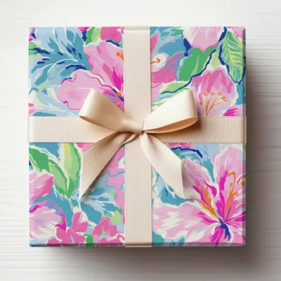 Gift box with a floral pattern and a cream ribbon bow.