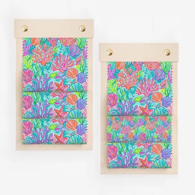 Two fabric swatches with a colorful coral reef pattern, mounted on wood.