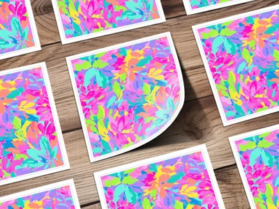 Colorful abstract floral pattern on cards scattered on a wooden surface.