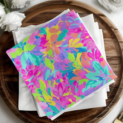 Colorful floral pattern on stacked white napkins on a wooden tray.